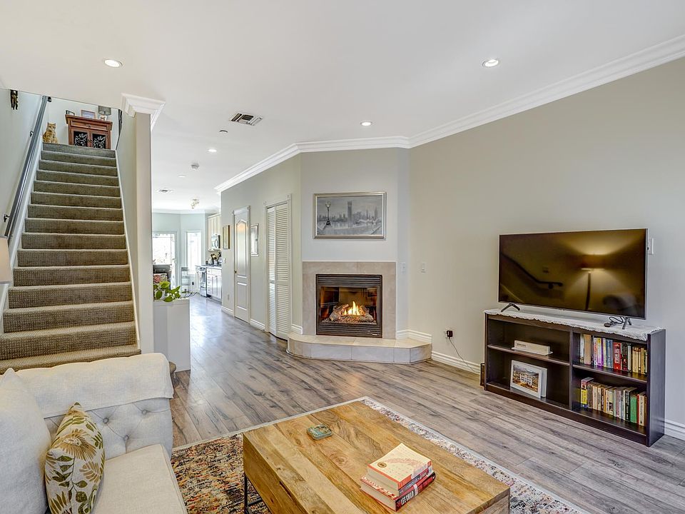 Living room showing large TV and stairs to second floor