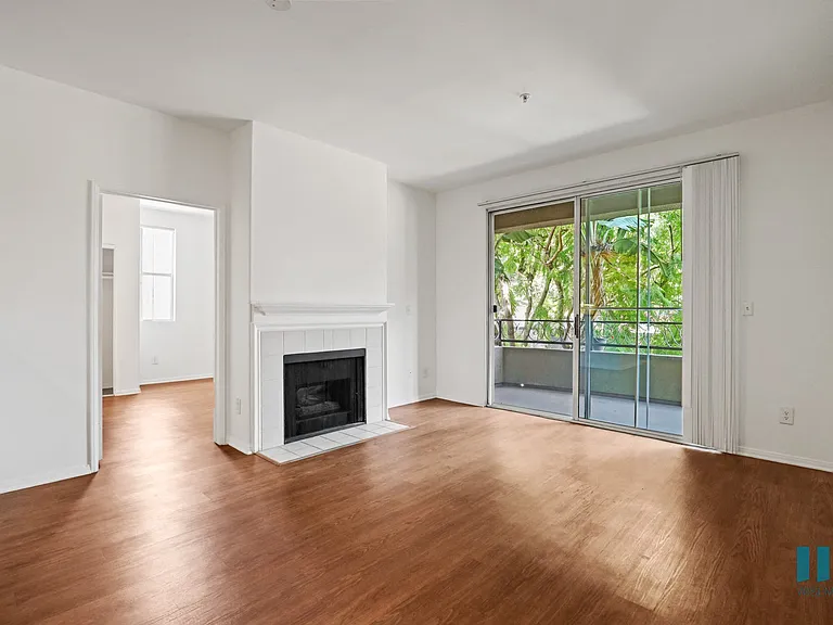 Living Room with Vinyl Flooring, Electric Fireplace, and Patio