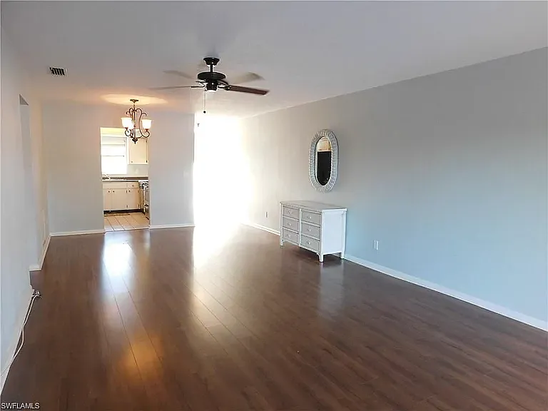 View of living room from sliding glass doors looking back toward dining area and then kitchen just behind. Front door is to the far right with the light coming in :)