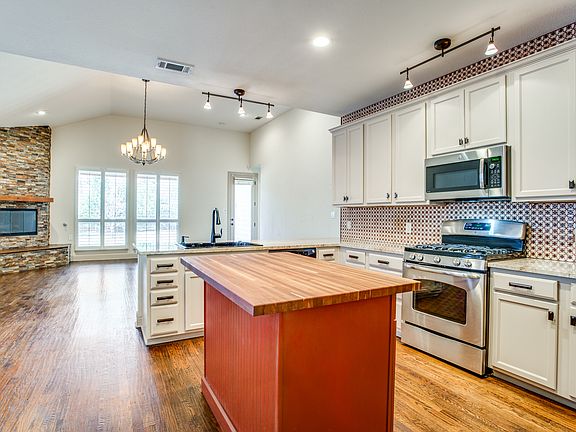 Ample cabinet space, a butcher block island, and stainless appliances_everything you want in a modern, functional kitchen.