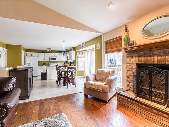 Beautiful engineered hardwood floors in the great room with a wood burning fireplace.