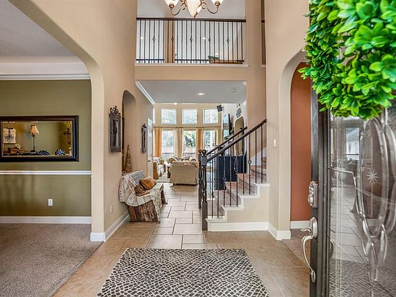 A wood and leaded glass front door leads to a two story foyer, with view right through to the beautiful back yard.