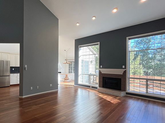 Living room is connected to kitchen, dining room, and upstairs deck.