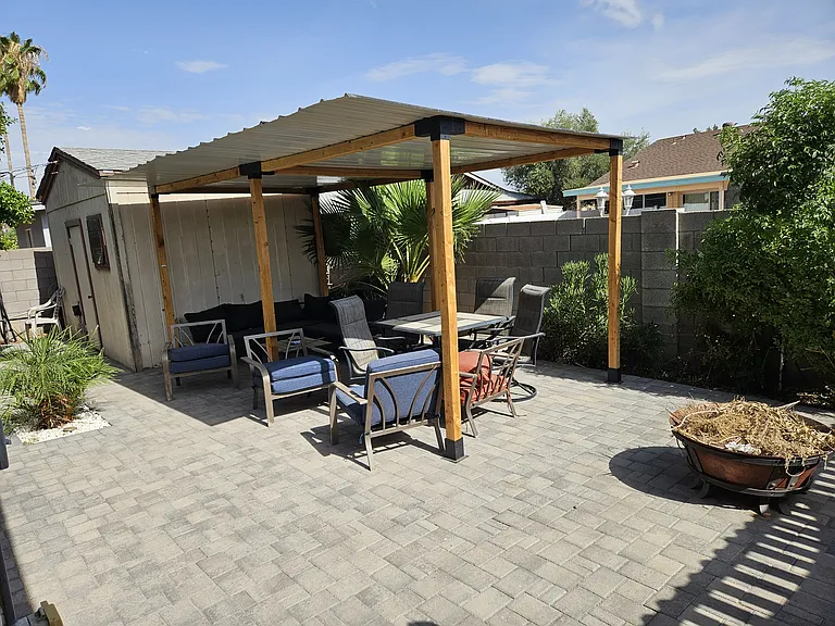Pergola with metal roof to provide shade on the back patio. The Shed can hold even more storage.