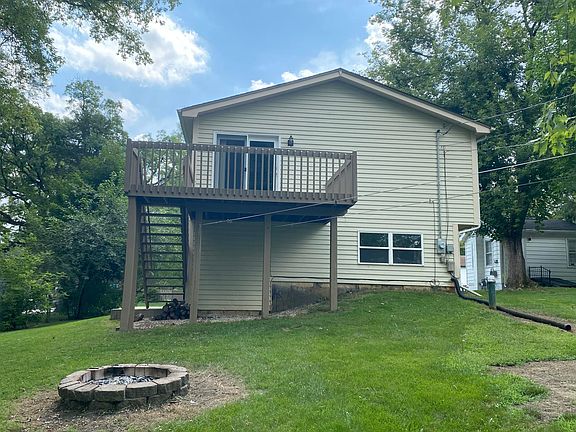 Back of house with fire pit