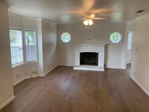 Large, bright living room with fireplace and new luxury vinyl plank floors