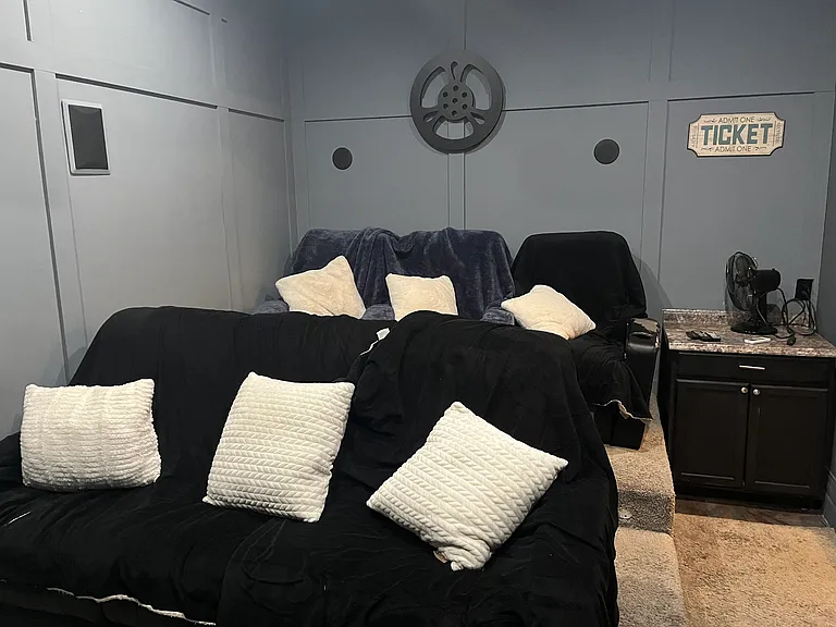 Third stall garage converted into a movie theater with six spots for viewing the game or latest movie together.