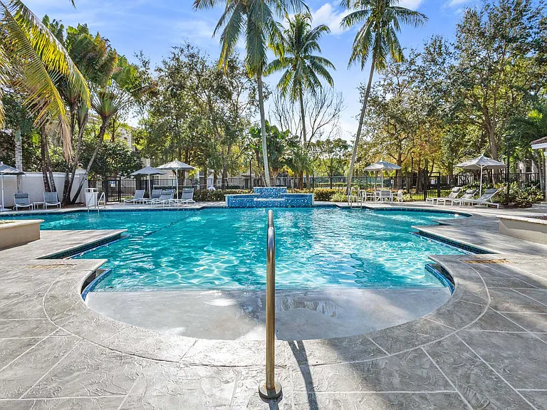 Take a dip in the large outdoor swimming pool, nestled among palm trees for a tropical, relaxing vibe.