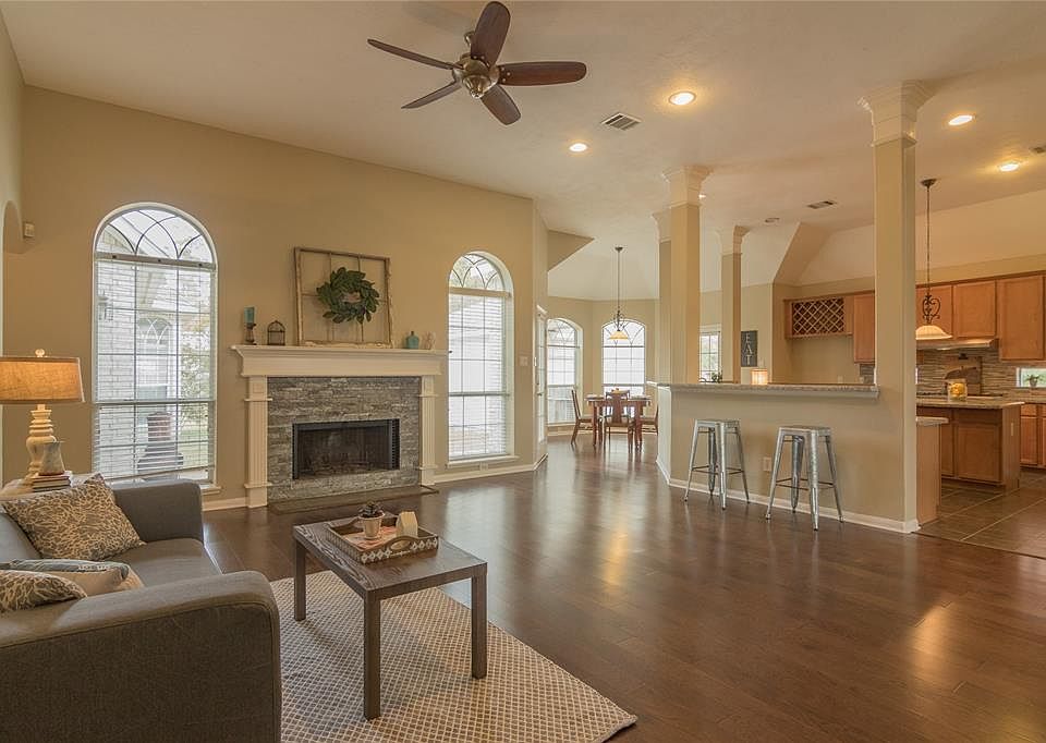 The warm and inviting den flows to the kitchen.