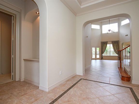 As you enter the home, the trayed ceiling in the foyer and inlaid tile floor make a grand first impression.