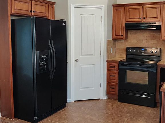 Kitchen with refrigerator provided