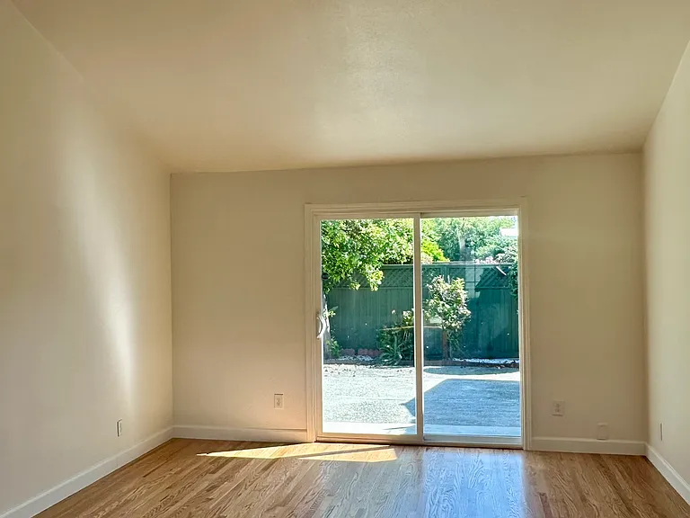 Expansive primary bedroom with sliding door to the backyard