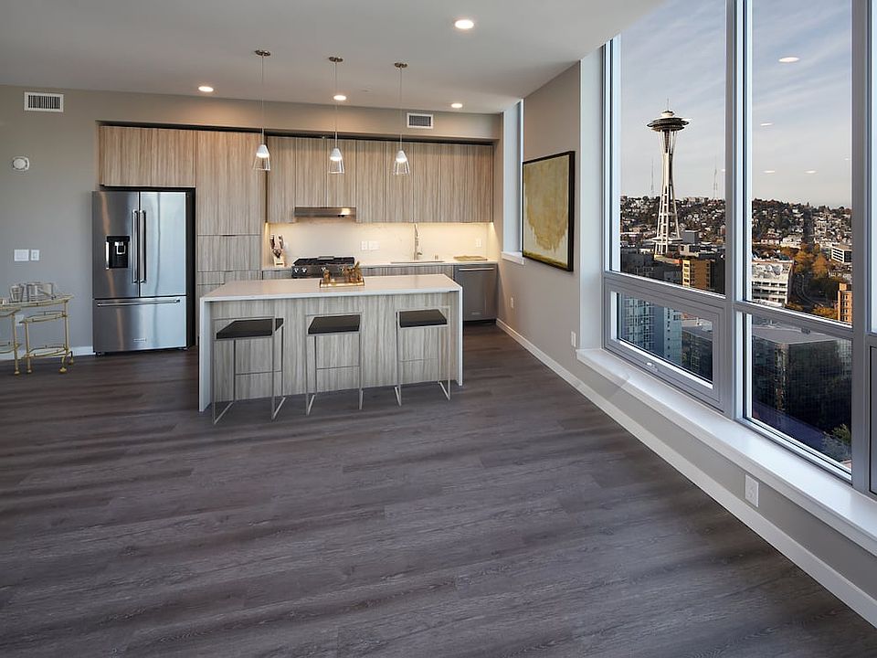 Signature Collection penthouse kitchen and dining area with hard surface flooring.
