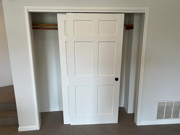 Full closet at end of living room
