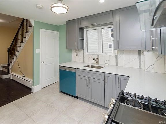 A few steps down the hall you will enter the renovated kitchen with neutral custom, soft close cabinets.