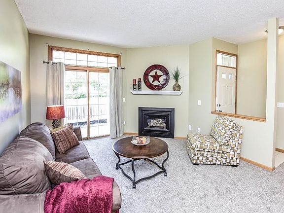Gas fireplace with simple white mantel.