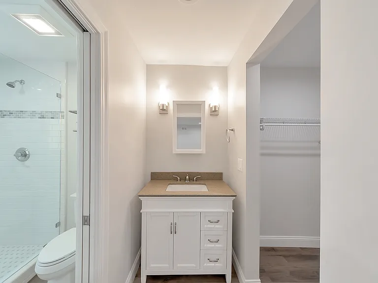 Updated en-suite bath with modern coastal finishes and a walk in closet.