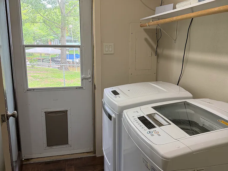 Utility area with door to fenced side yard