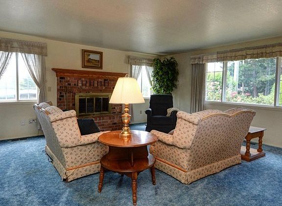 Step inside to the Living Room, where the big fireplace keeps it