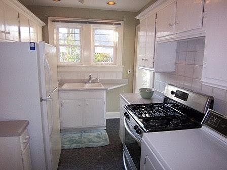 Compact kitchen has plenty of storage, gas cooking and laundry!