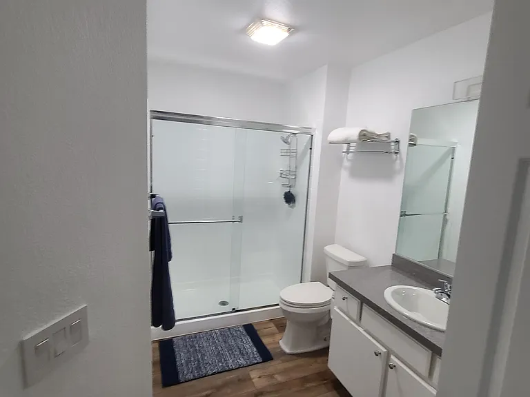 Pristine hall bathroom with dual access_connects seamlessly to the middle bedroom, offering the comfort and convenience of an en suite. ____