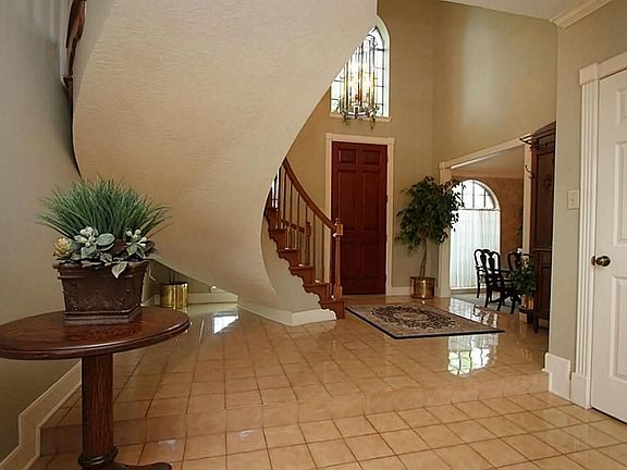 Another view of the foyer with tile floors and high ceilings.