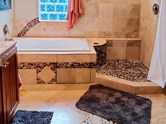 Spacious shower with window. Jacuzzi tub.