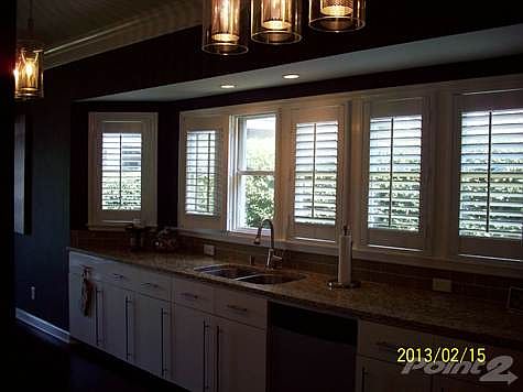 END UNIT WINDOWS PROVIDING AN ABUNDANCE OF NATURAL LIGHT IN THE KITCHEN