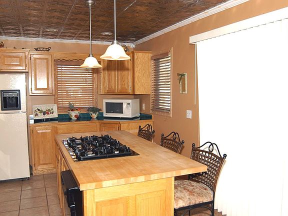 Gourmet Kitchen with ceramic floors, center island and W/O to deck