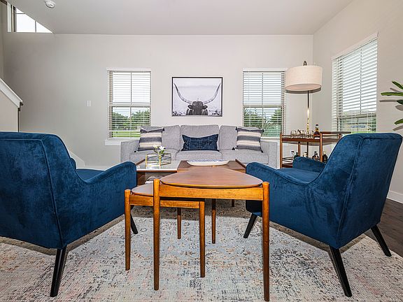 Living Room with Natural Light, Wood Style Flooring, and Window Shades