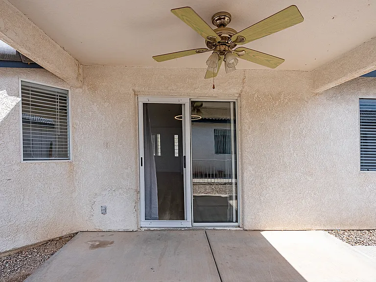 Covered patio just outside the back slider. Kitchen window to the left. Master bedroom window to the right.