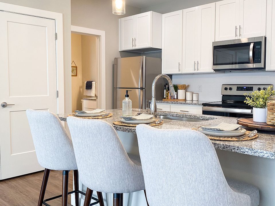 An open kitchen with modern appliances and a breakfast bar that's both functional and stylish.