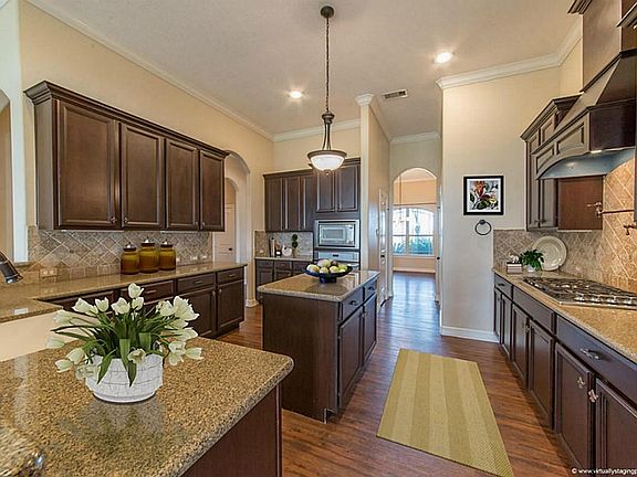 Any cooks dream kitchen with tons of cabinet space and counter tops equipped with walk-in pantry. Cherry wood custom cabinets (virtually staged)