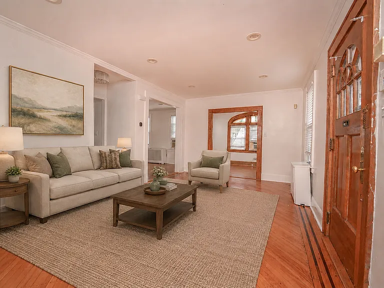 Entrance into living room with office view and dining room view. 
Virtually staged