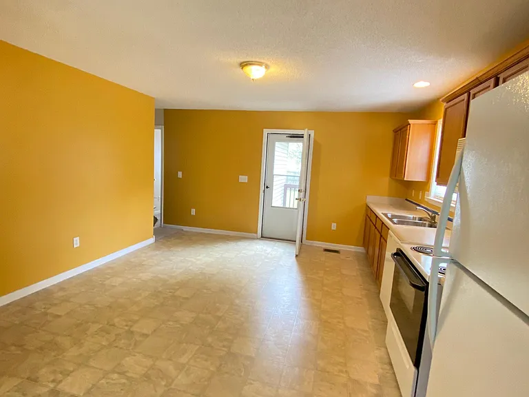 This pic is old. Floors have a laminate on them in kitchen area