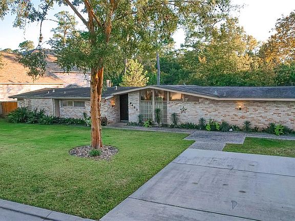 Double driveway plus driveway to two car garage located behind property.
