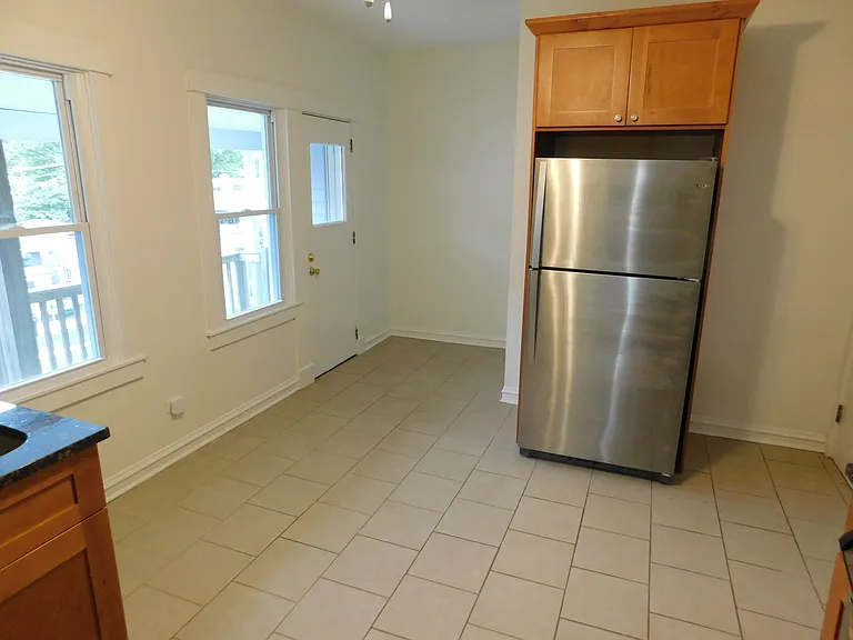 Kitchen has area for table and access to the porch.