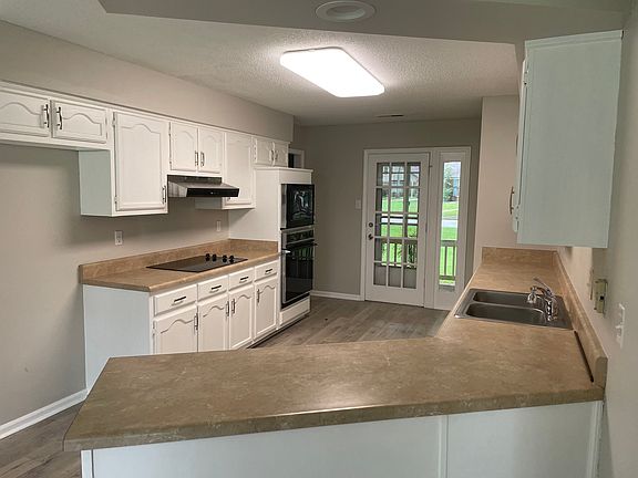 Kitchen has front door leading to front porch for coffee