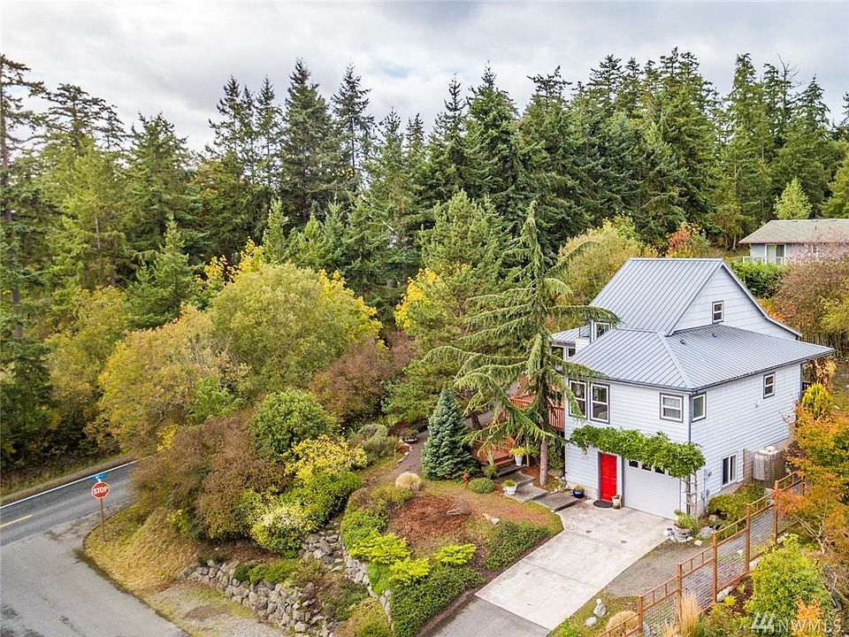 Mature landscaping on a corner lot sits this well designed home.
