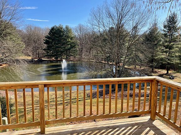 Back deck for sunshine and relaxing seasonal views of the neighborhood pond