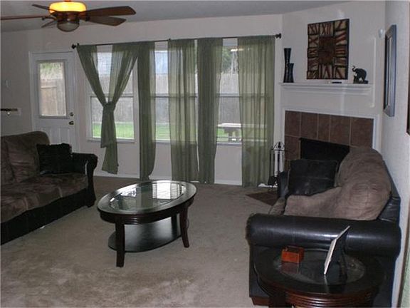 LIVING AREA WITH PLENTY OF WINDOWS AND FIREPLACE