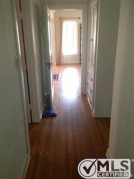 Beautiful hardwood floor glow towards front door. Built-in storage on right.
