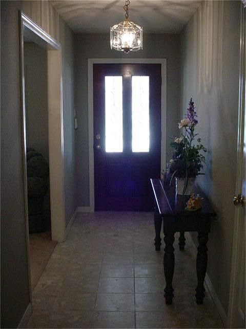 Entry has stone tile, nice door with storm door.