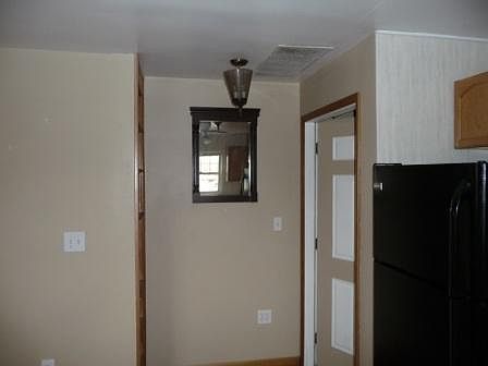 Inviting entrance, with beautiful two-tone door, expresso, wood mirror and fancy glass lighting.