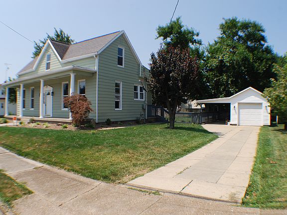 side with garage and carport