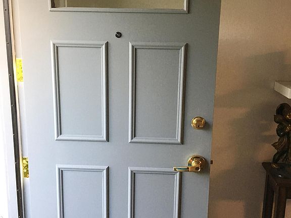 Freshly painted door leading to the back deck and large shared backyard