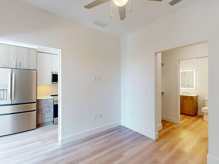 Spacious apartment Bedroom with Large Closet, Attached Bathroom and wood-style flooring