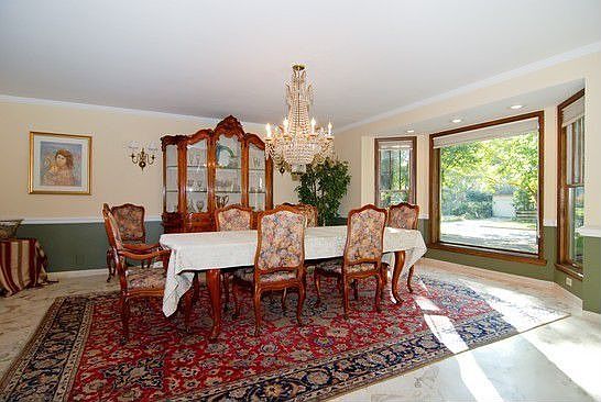 Formal dining room with marble flooring.