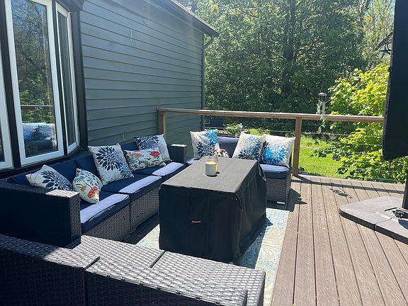 Fully furnished deck with seating for 10 and a giant 12-foot umbrella that shades the entire lounge area
