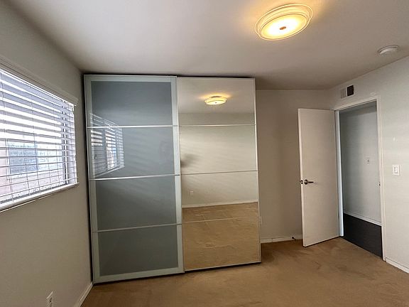 open bedroom comes with built in dresser for storage